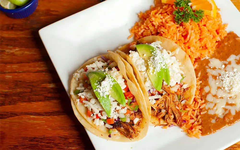 El Jardin tacos served with rice and beans